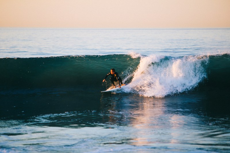 surfer surfing the wave during sunrise at 54th street, surfer surfing the wave 4k
