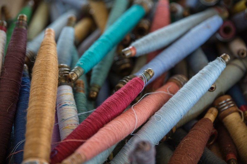 pile of multicolored craft threads and spools close up in springfield, pile of thread 4k