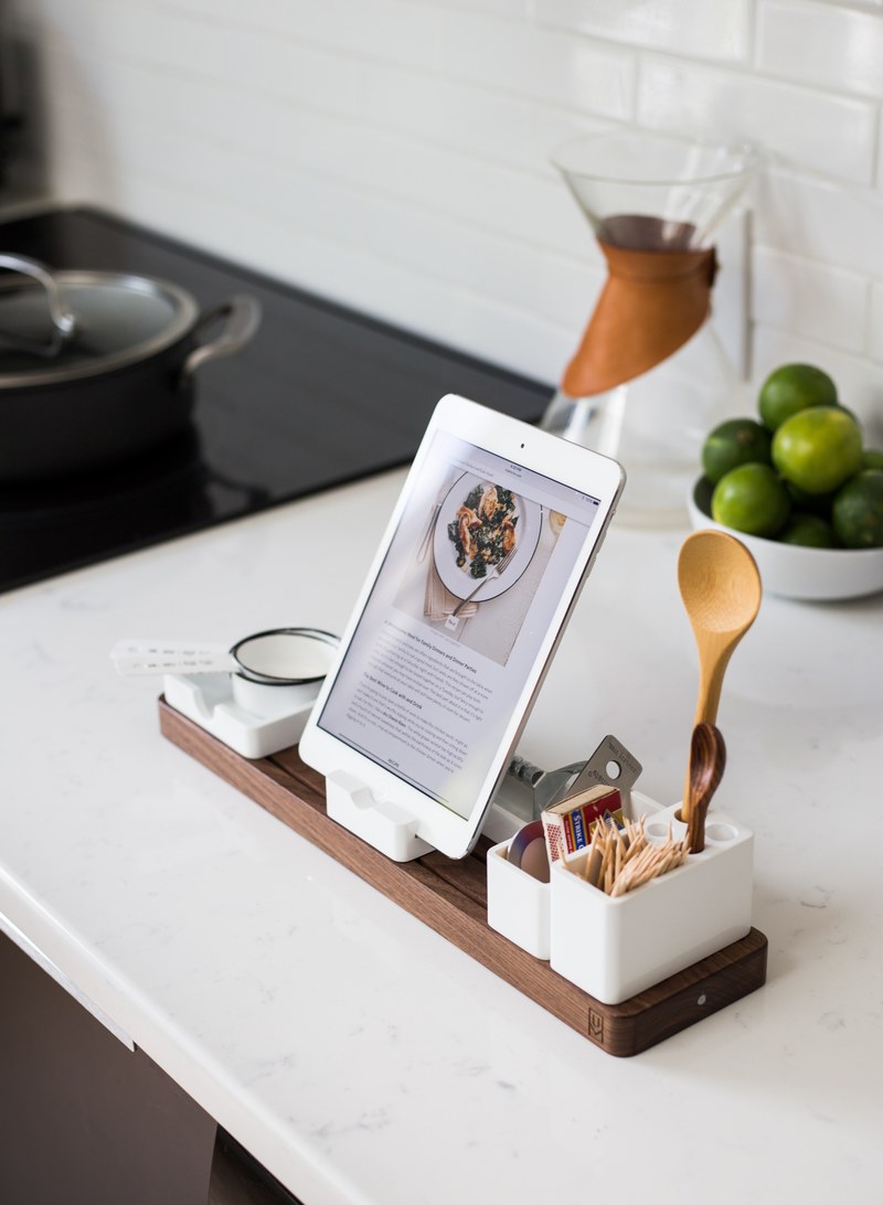 an ipad in a dock surrounded with kitchen utensils in a kitchen, gather 4k