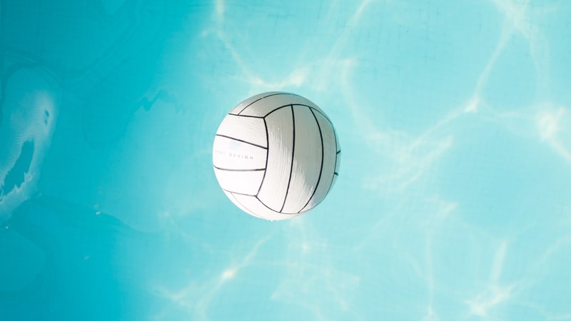 a white water polo ball floating in a swimming pool in sopron, water polo ball floating 4k