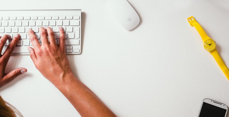 the hands of a designer typing on the keyboard connected to a computer in an office setting, _typing on a keyboard 4k
