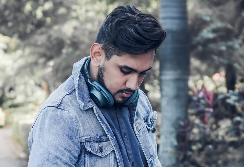 man with tousled hairstyle wearing headphones around his neck, music headphones 4k