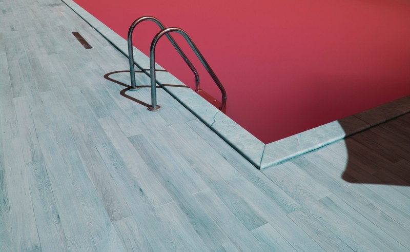 a shot of a ladder leading into a red water pool, red water swimming pool 4k