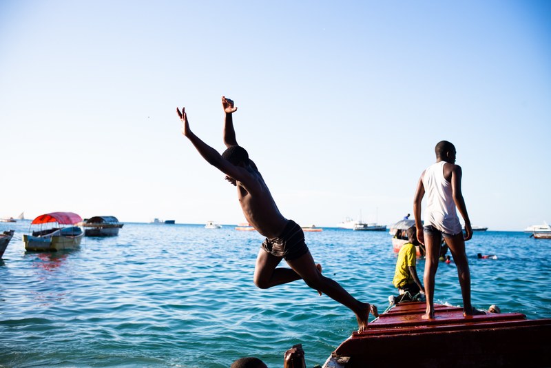 a person jumping off a dock into the water, _be free 4k