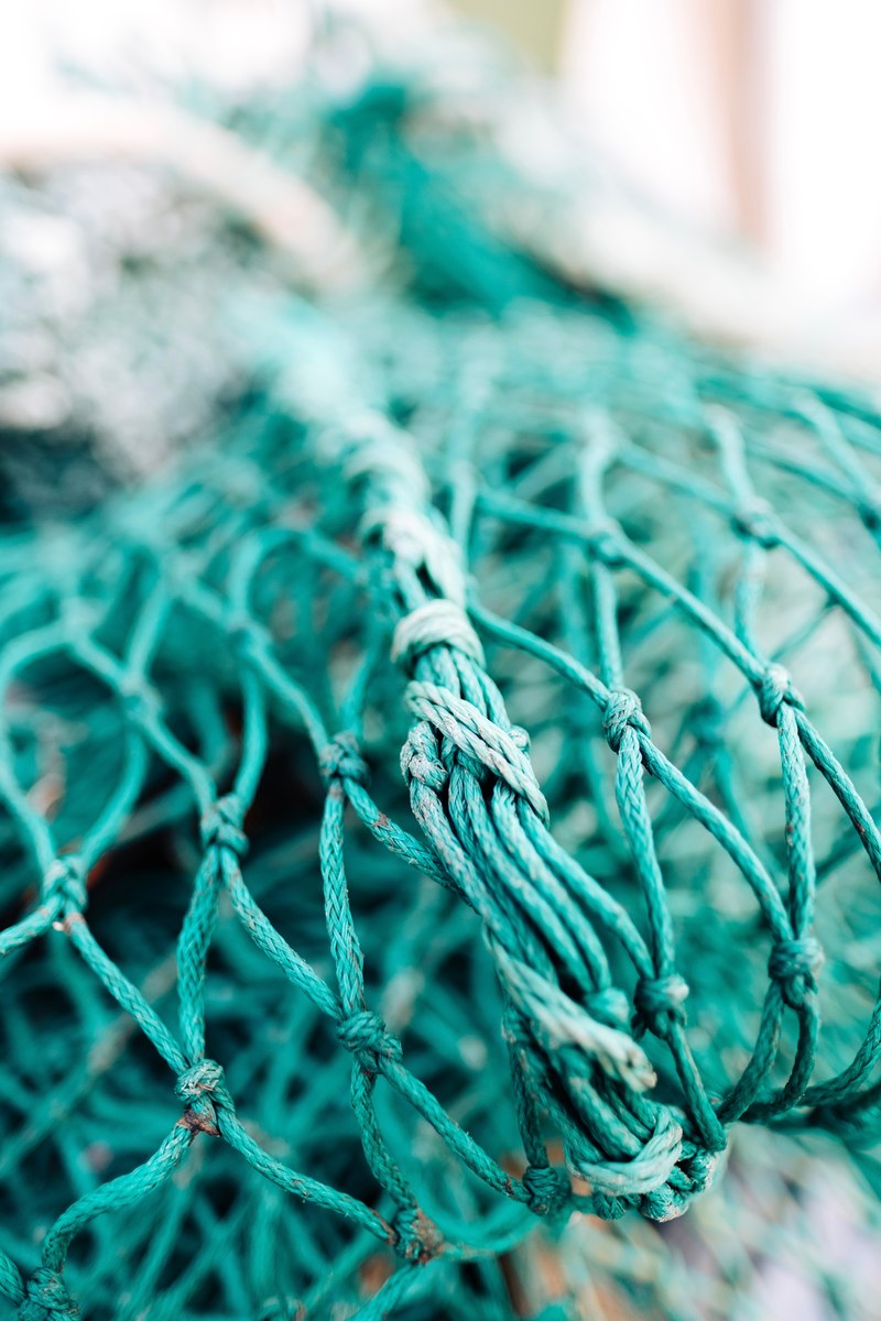 a macro photo of a green fishing net up close in kldesholmen, fishing net 4k