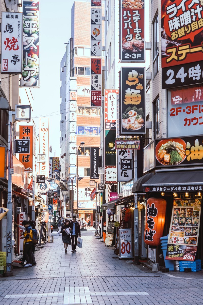 shot of a shinjuku street filled with restaurants and signs during the afternoon, food 4k
