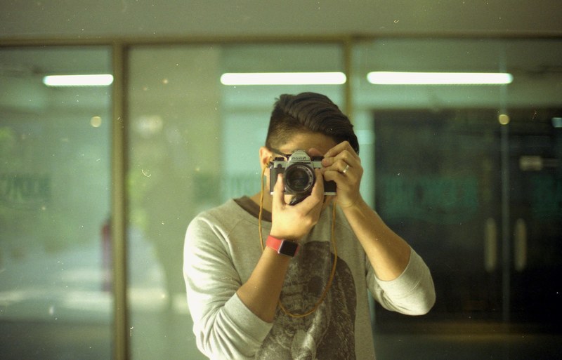 a man wearing an apple watch taking a photo with a vintage camera, so this is me 4k