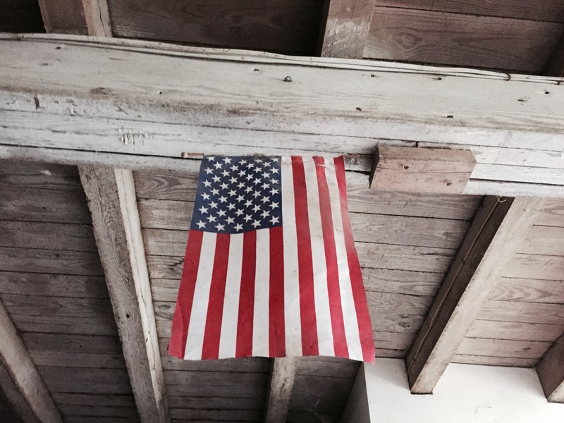 the american flag hanging from a wooden ceiling, american flag on the ceiling 4k