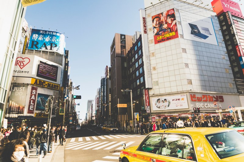 a square in tokyo with pedestrians crowding the sidewalks, tokyo japan 4k