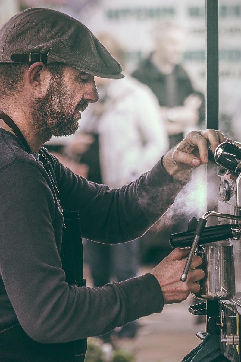 a barista pouring coffee from a coffee machine, barista pouring coffee 4k
