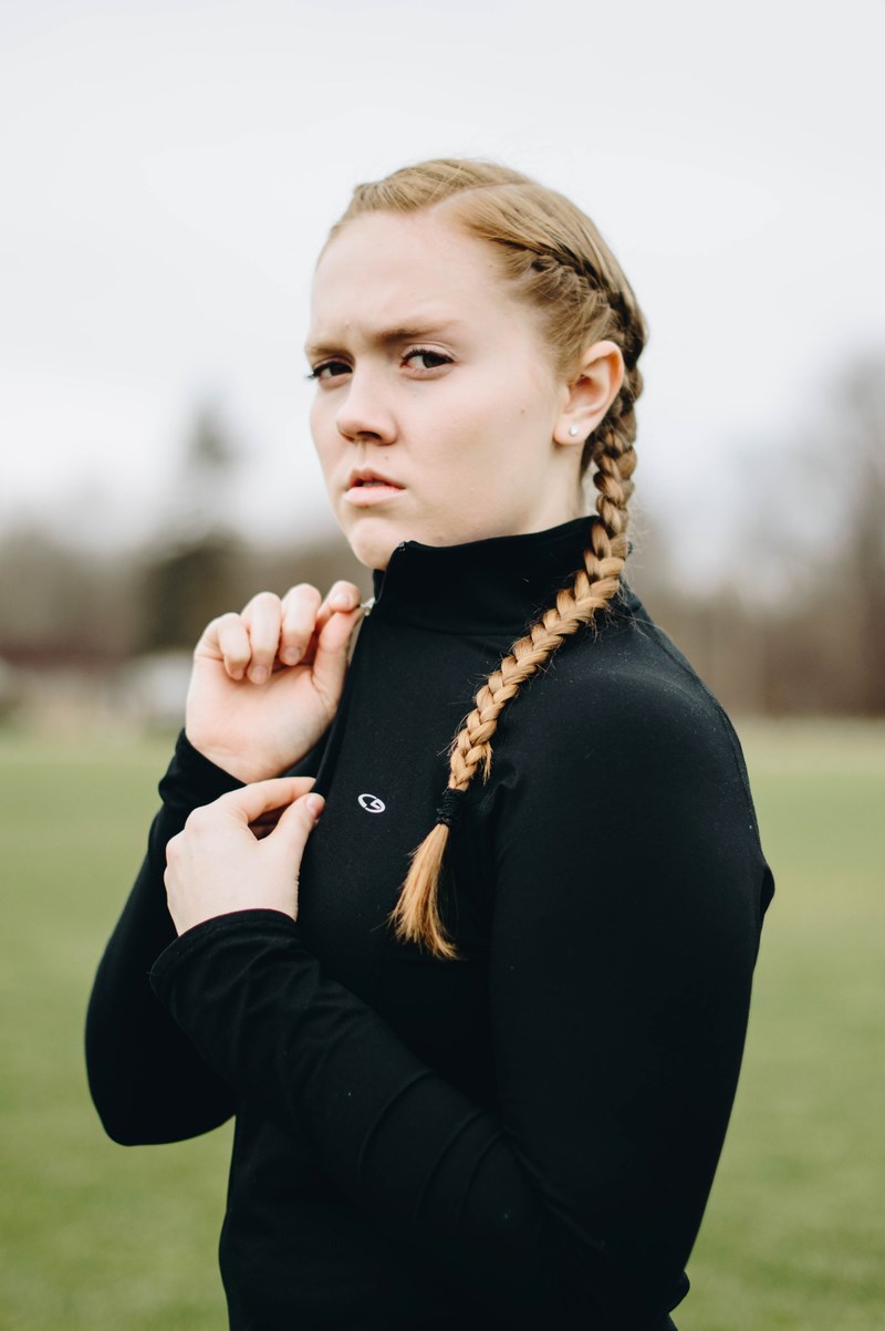 angry woman with brains zips up her jacket and frowns, the ultimate athlete 4k