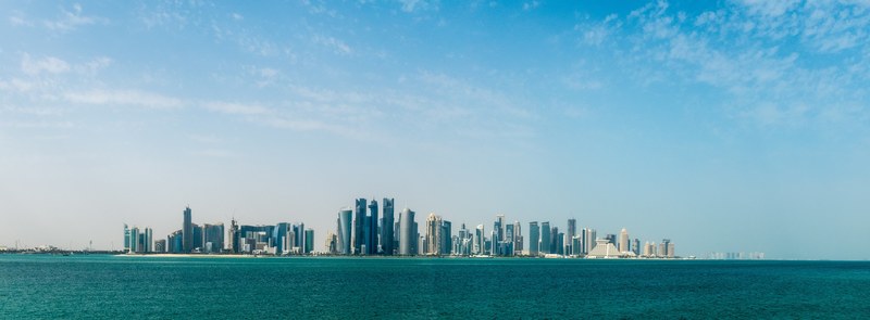 a panorama shot of an impressive city skyline by a body of water, city skyline in panorama 4k