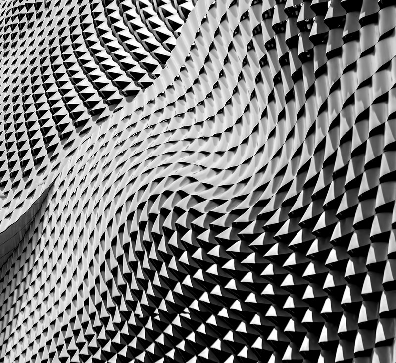a curved gray facade with gray metal sheets, dancing roof 4k