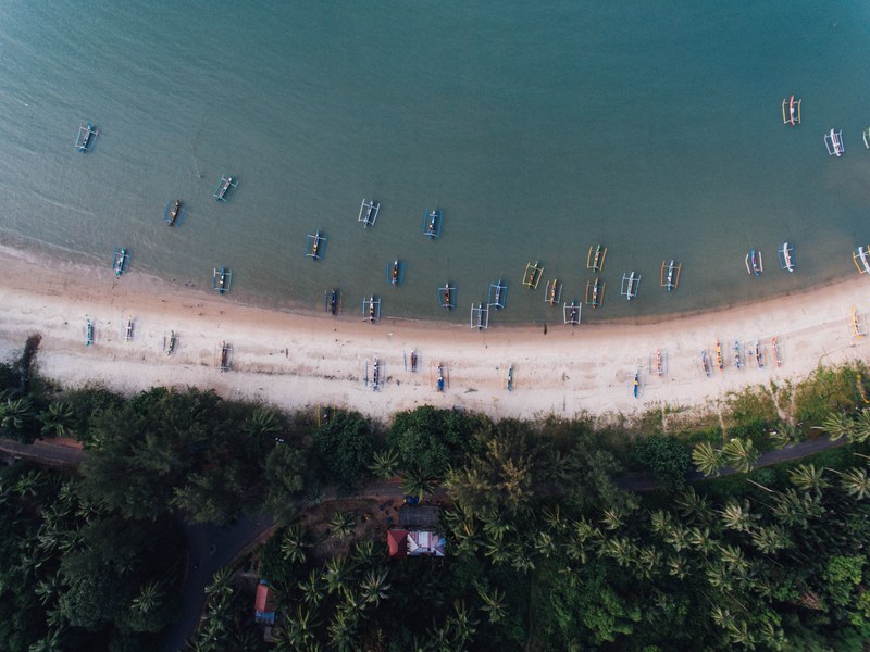drone view of traditional fishing catamaran boats in the shallow waters at belitung, fishing catamarans drone view 4k