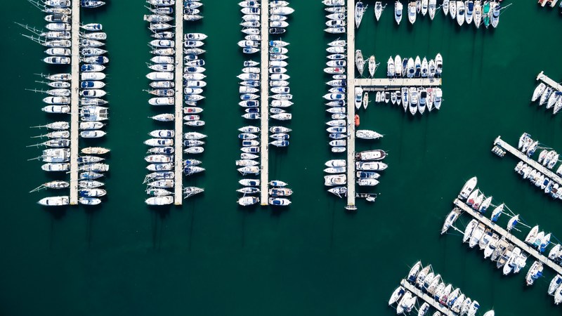 a drone shot of a large number of boats moored at a marina in dnia, moored boats from above 4k