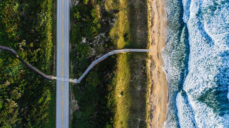 drone aerial view of a road along the sand beach coastline at ponte vedra beach florida united states, road to shore 4k