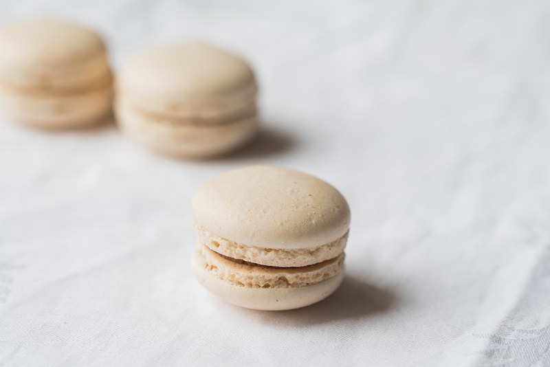 fresh macarons on a white tablecloth, minimalist macarons 4k