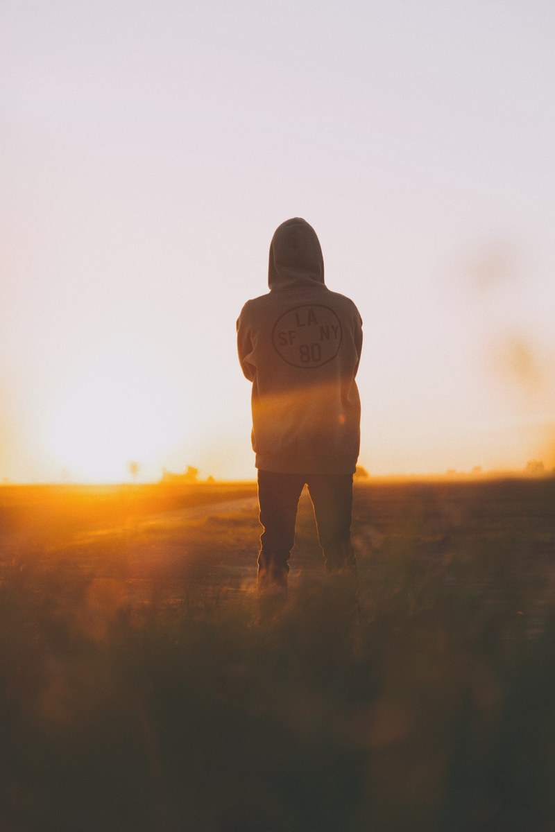 a man standing in a field in mexicali watching the sunset, mexicali sunset 4k