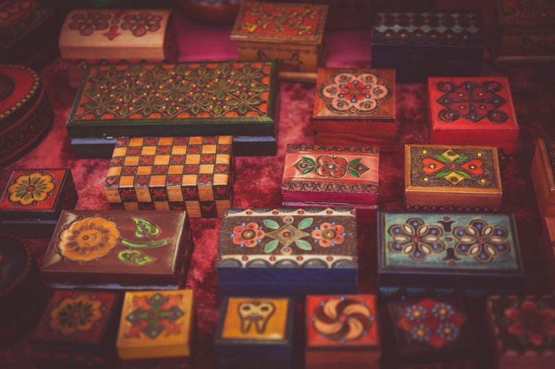 assorted woodwork boxes collection with varied floral art designs on red fabric surface in cambridge, decorated wood boxes 4k