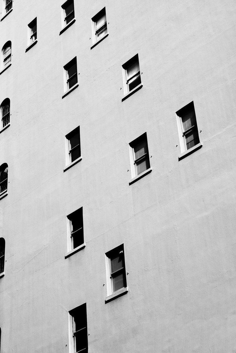 the exterior of a white building with randomly placed windows on each floor, _windows 4k
