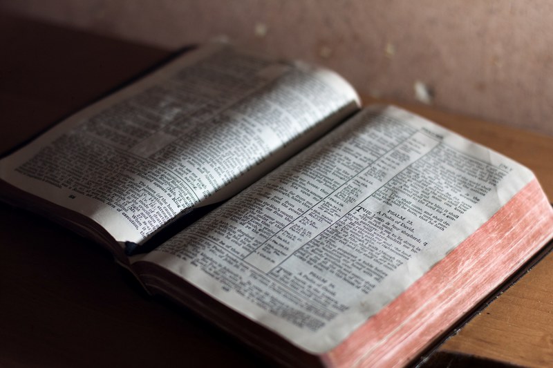 old vintage bible with worn pages open to a reading, bible 4k