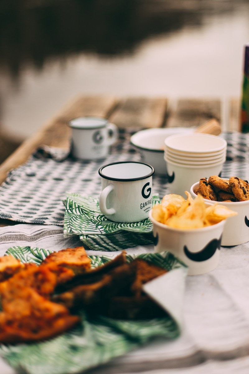 picnic table with cups of chips cookies and grilled food, picnic 4k