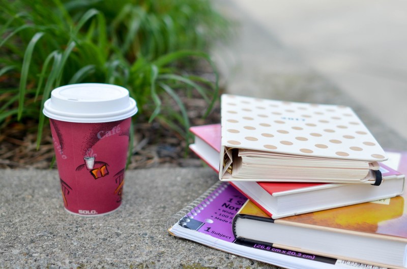 books and coffee cup on a ledge near a plant royal oak, royal oak coffee break 4k