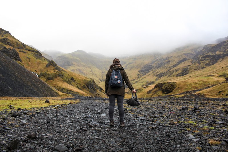 hiker stands in wet rocks on a foggy walk through eyjafjallajkull, unsplash expedition part ii 4k
