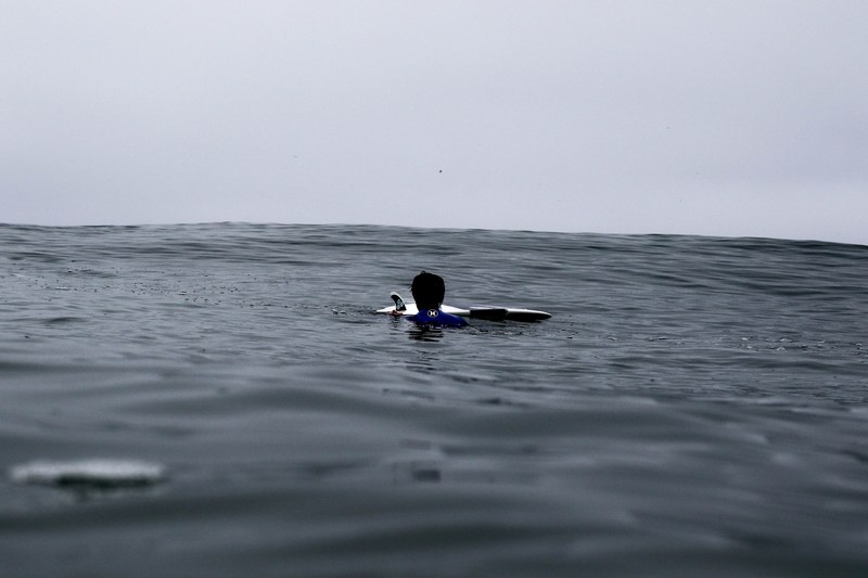 surfer with a surfboard swimming in the ocean at newport beach, quick fix 4k