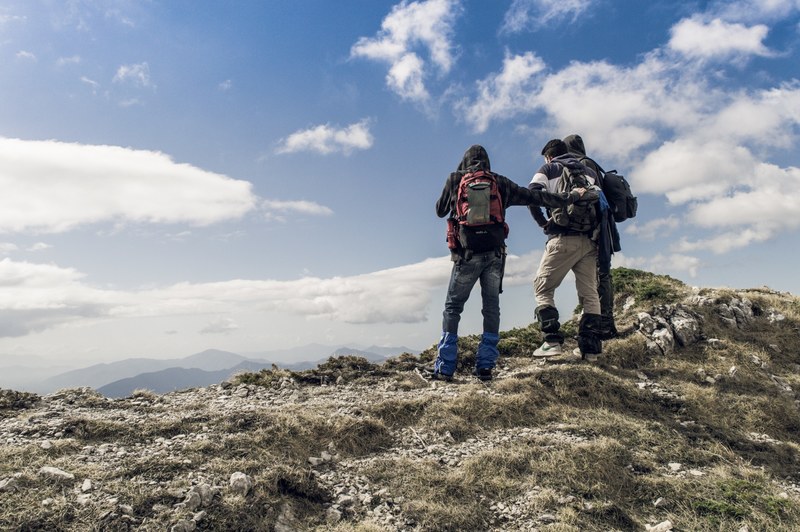 hikers standing on a rocky mountain peak in filignano looking at the sky and the hills, filignano hikes 4k