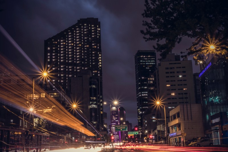 a dark city background featuring large buildings and street light trails in bogot, bogot city and street lights 4k