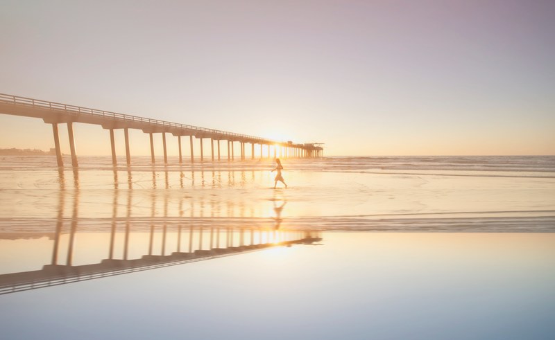 woman walking on the wet sand beach by the pier at sunset in san diego, woman walking on a beach 4k