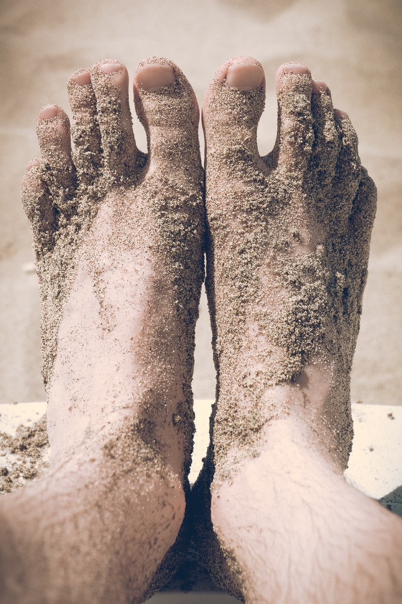 view of the feet covered in beach sand, feet covered in beach sand 4k