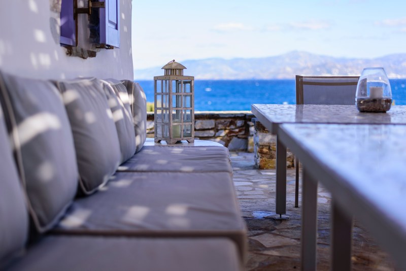 sofa and tables on the outdoor terrace overlooking the ocean, terrace with ocean view 4k