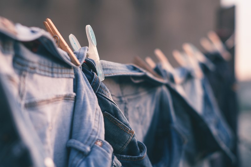 denim clothes hanging from laundry line in juiz de fora yard, hanging denim to dry outside 4k
