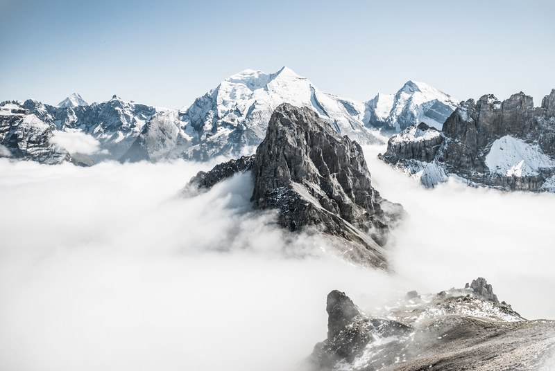 snowy mountain tops cut through an expanse of clouds, mountain tops above clouds 4k