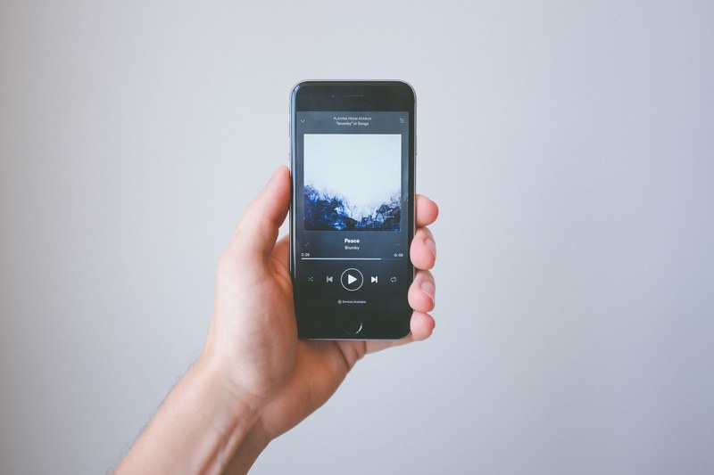 smartphone held in hand displays spotify music application, spotify on smartphone 4k