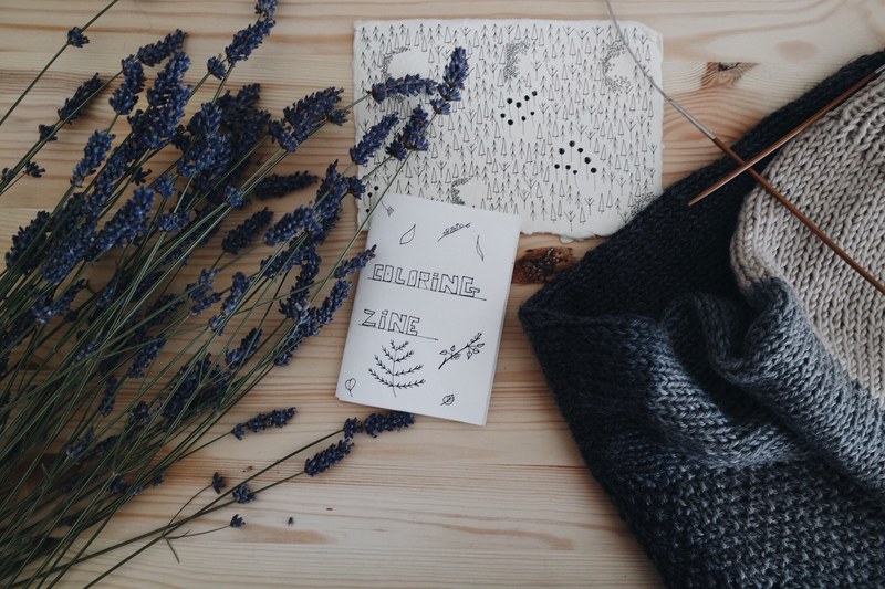 flat lay of artists desk with coloring book zine lavender plants and a scarf, artists work space 4k