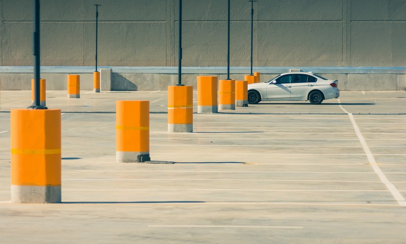 wide angle shot of a lone white car in a large parking lot, _parking isolation 4k