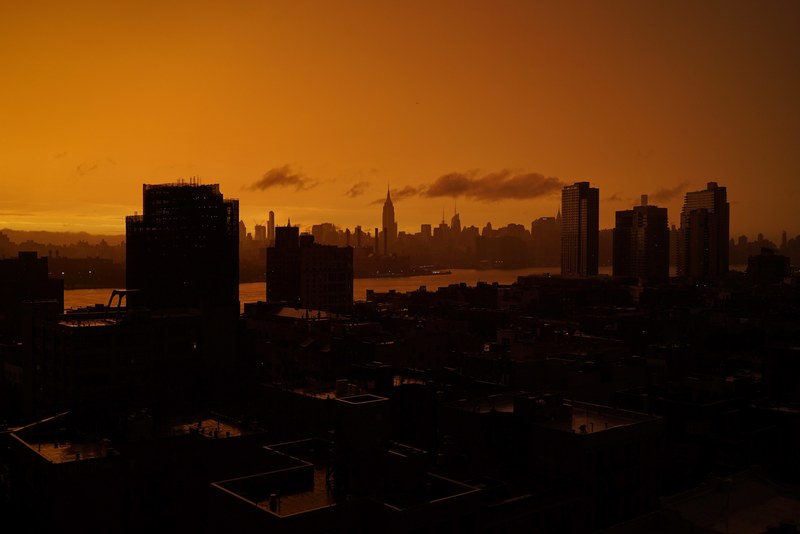 a dim skyline of williamsburg at sunset, orange 4k