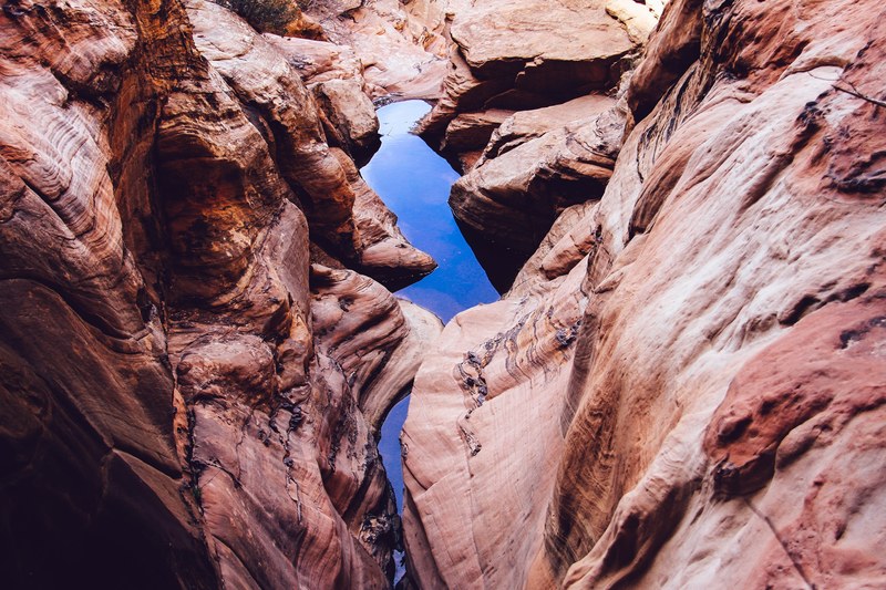 view down a sandstone ravine with a stream on its bottom, view down a ravine 4k