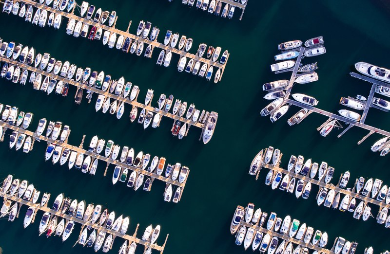 a drone shot of boats moored at a marina, aerial view of a marina 4k