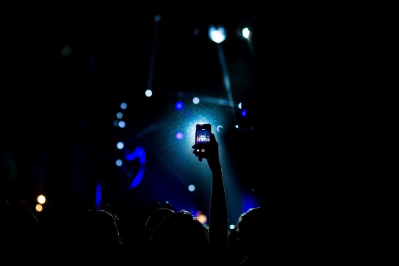 the silhoutte of a person holding up their iphone cellphone at a concert in monterrey, monterrey concert silhouette 4k
