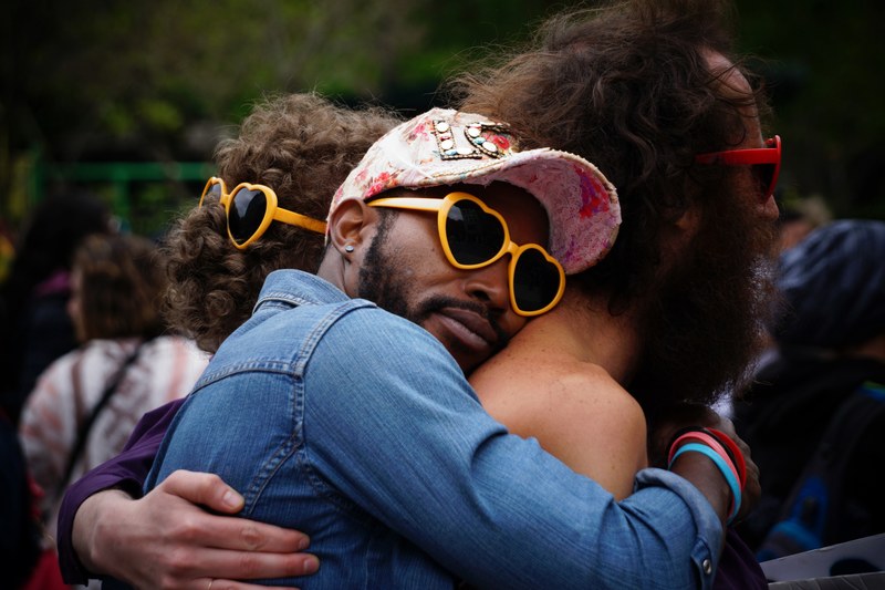 group hug between men of different races wearing heart shaped sunglasses, love is all around 4k