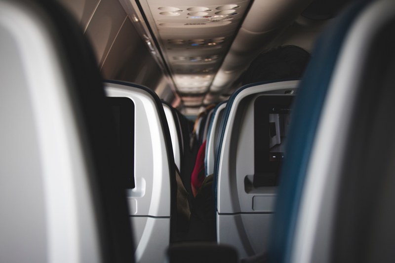 a view on the gap between the rows of airplane seats, plane seat rows 4k