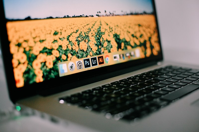 blurry close up of a macbook displaying the desktop, macbook pro 4k