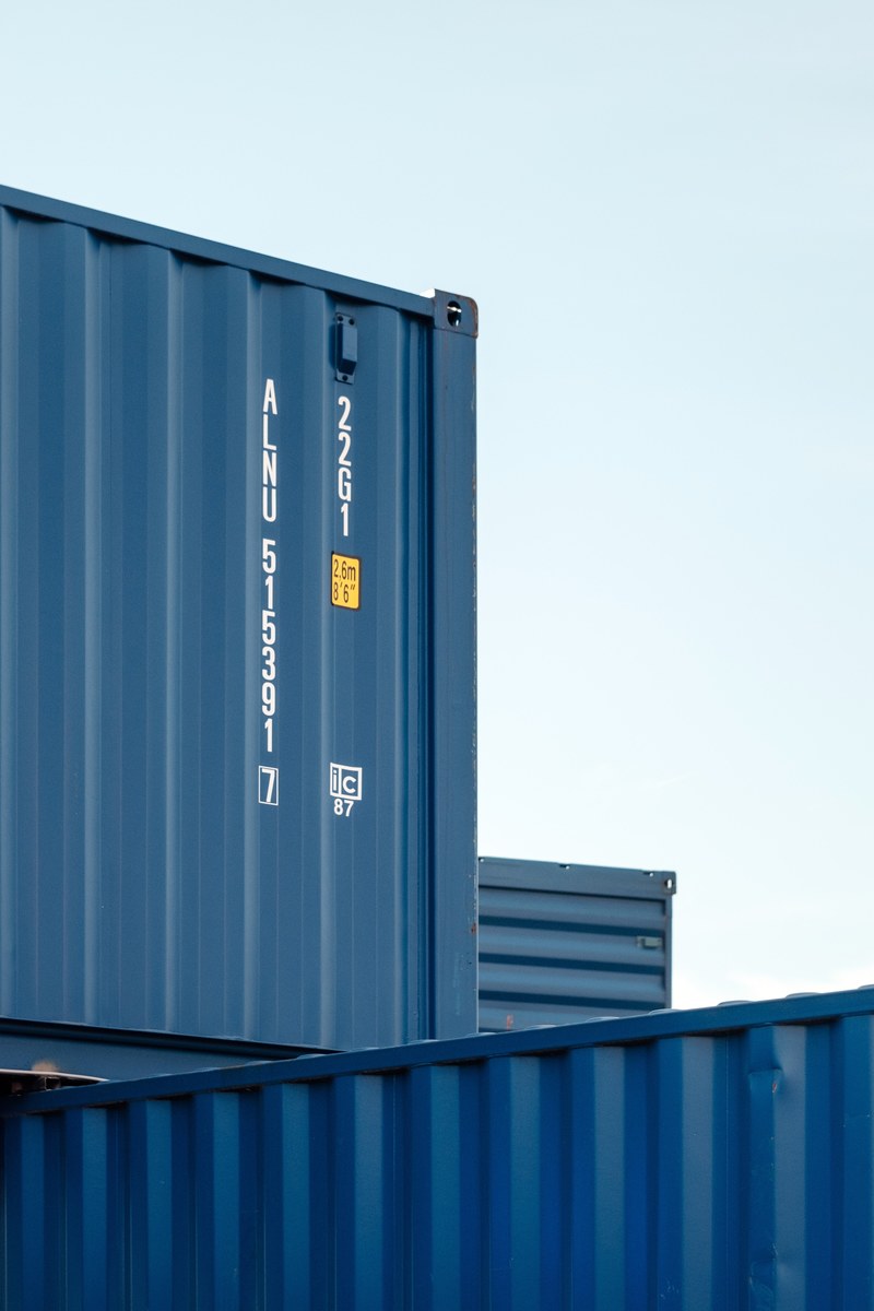 stacks of blue shipping containers at a loading dock, shipping containers 4k