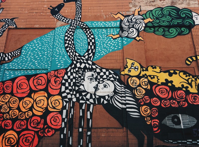 a wall painting of black and white checkered distorted man and woman kissing surrounded by flowers a yellow cat the sun and more, _black white checkered graffiti 4k