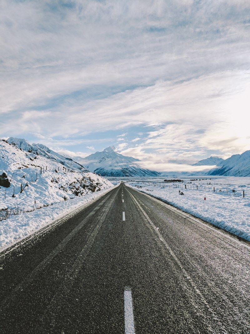 an empty road near snow covered mountains, _the most beautiful road in the world 4k
