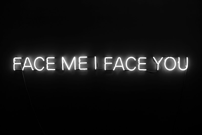 face me i face you white neon sign at work on dark background phoenix art museum, neon sign in black room 4k